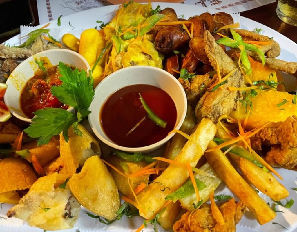 Authentic Panamanian food sampler. Fried yucca, wings, carimanolas.