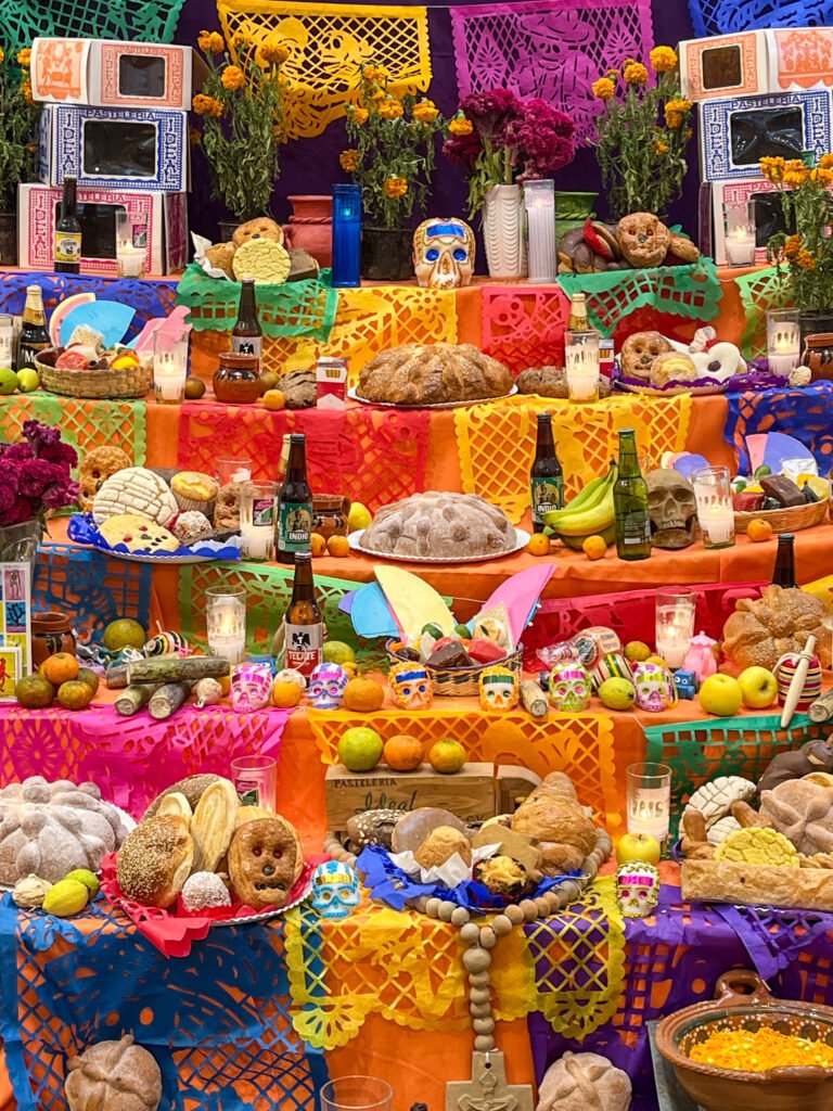 A colorful Dia de los Muertos altar welcomes visitors at Ideal bakery.