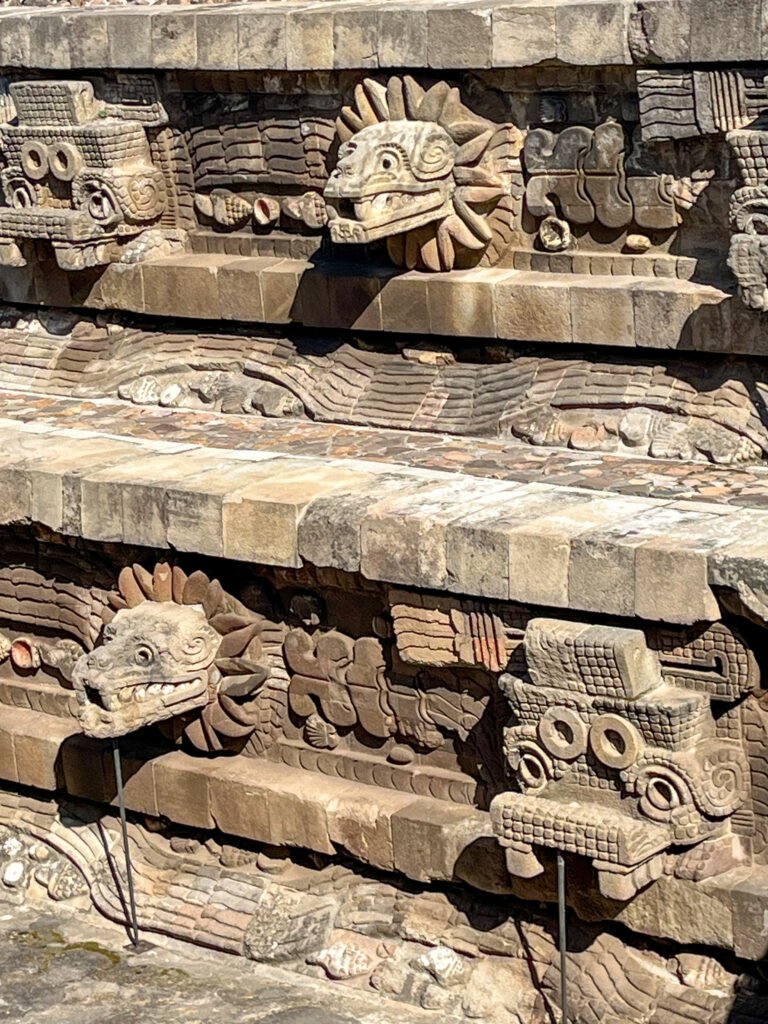sculptures of the feathered serpent and crocodile